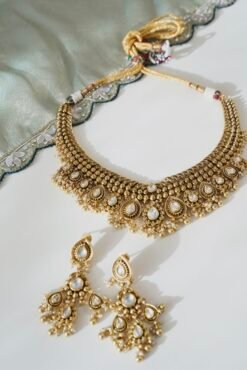 Kundan gold tone necklace set with matching earrings featuring tiny pearl drops and a royal traditional design