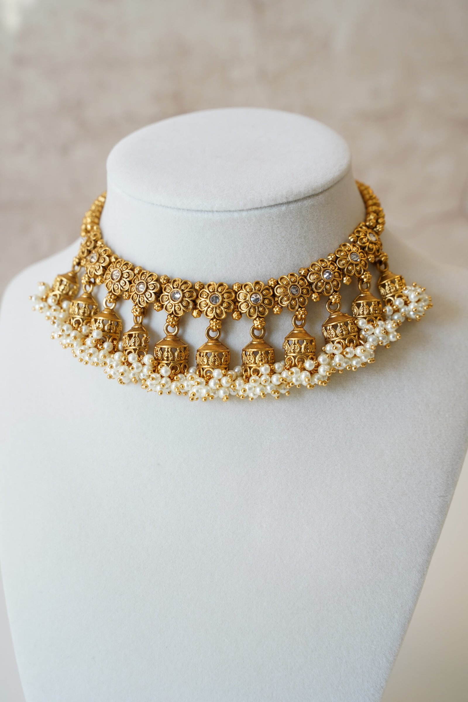 Gold tone mini multi jhumka necklace set with matching earrings, featuring delicate hanging jhumka drops for a traditional yet modern look