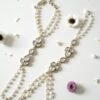 Delicate haathphool hand harness featuring kundan stones and tiny pearl detailing with fine chains