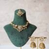 Small delicate floral kundan gold necklace set with jhumka earrings and matching tikka in traditional Indian design 