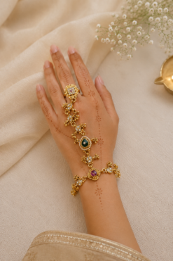 Adjustable gold haathphool hand jewelry with intricate ethnic design, perfect for Indian and Pakistani bridal wear