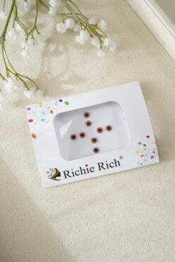 Classic matte maroon round bindi for traditional South Asian styling.