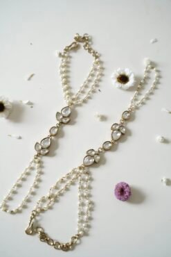 Delicate haathphool hand harness featuring kundan stones and tiny pearl detailing with fine chains