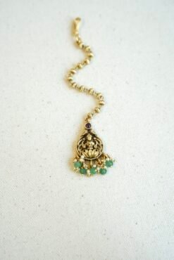 Traditional temple style tikka with elegant green bead accents for bridal, festive, and cultural wear.