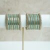 Blue metal bangle stack featuring statement kata bangles on each end, perfect for summer weddings and festive occasions.