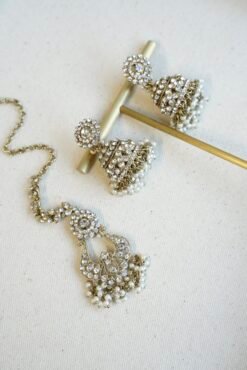 Three piece adjustable sparkling stone choker necklace set with matching earrings and a maang tikka with hanging pearl beads by Seyora Jewels.