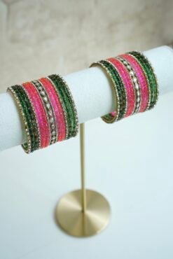 green and pink glass bangle stack with statement kundan centerpiece bangles for weddings and festive wear.