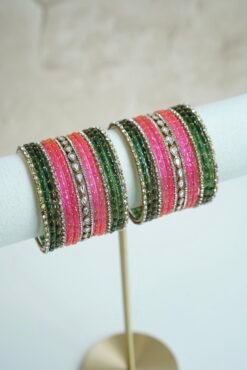 green and pink glass bangle stack with statement kundan centerpiece bangles for weddings and festive wear.