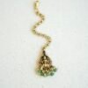 Traditional temple style tikka with elegant green bead accents for bridal, festive, and cultural wear.