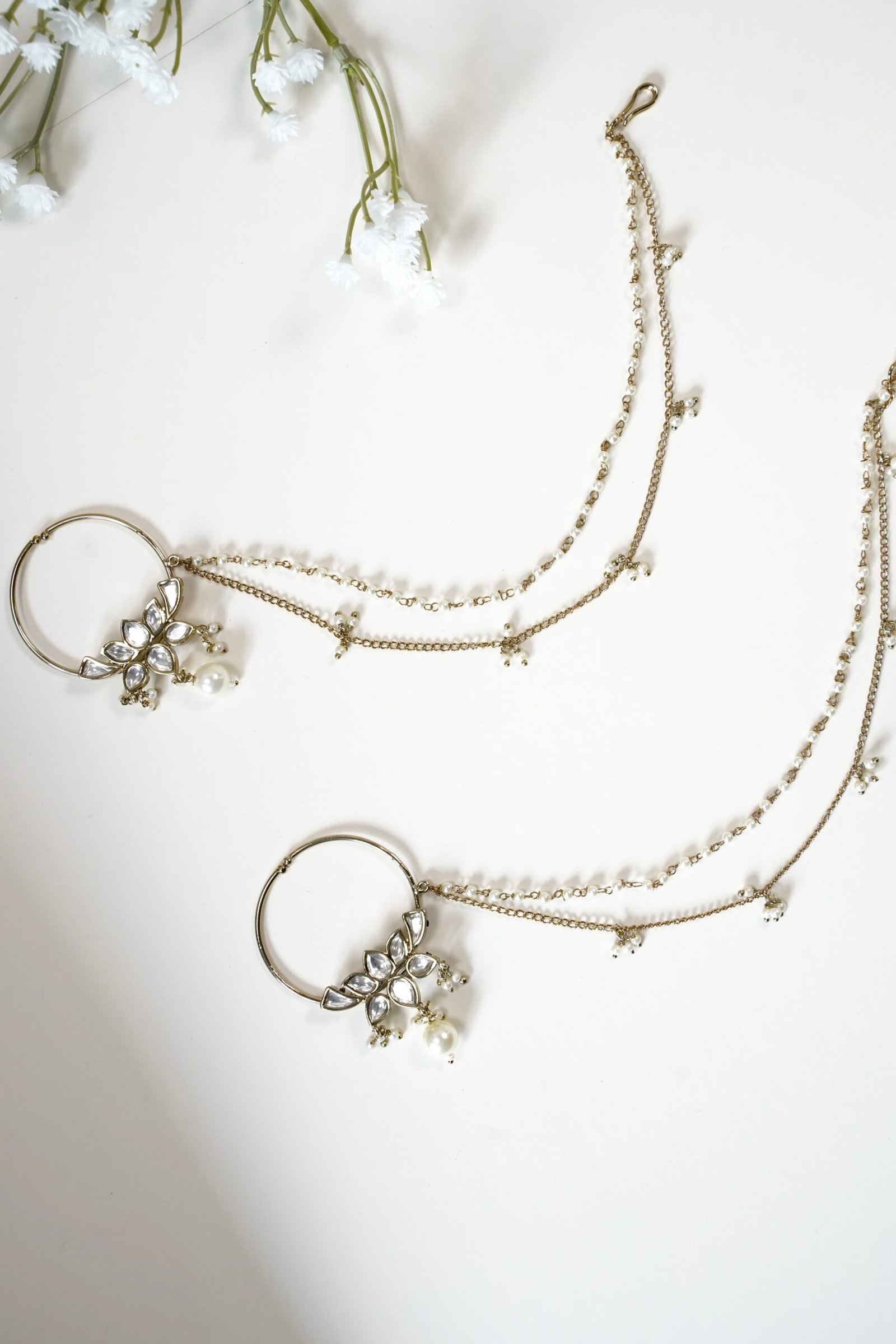 Mehndi polish Kundan nath featuring a lotus design, hanging pearl, and two-layer pearl chain by Seyora Jewels.