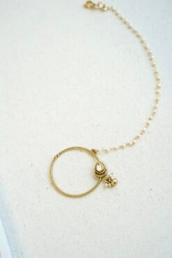 Oversized oval Kundan nath featuring a matte gold finish and a single-layer sleek chain by Seyora Jewels.