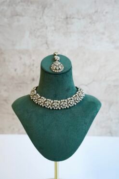 Delicate and sparkly small stone necklace set with matching drop earrings and pendant tikka reflecting light.