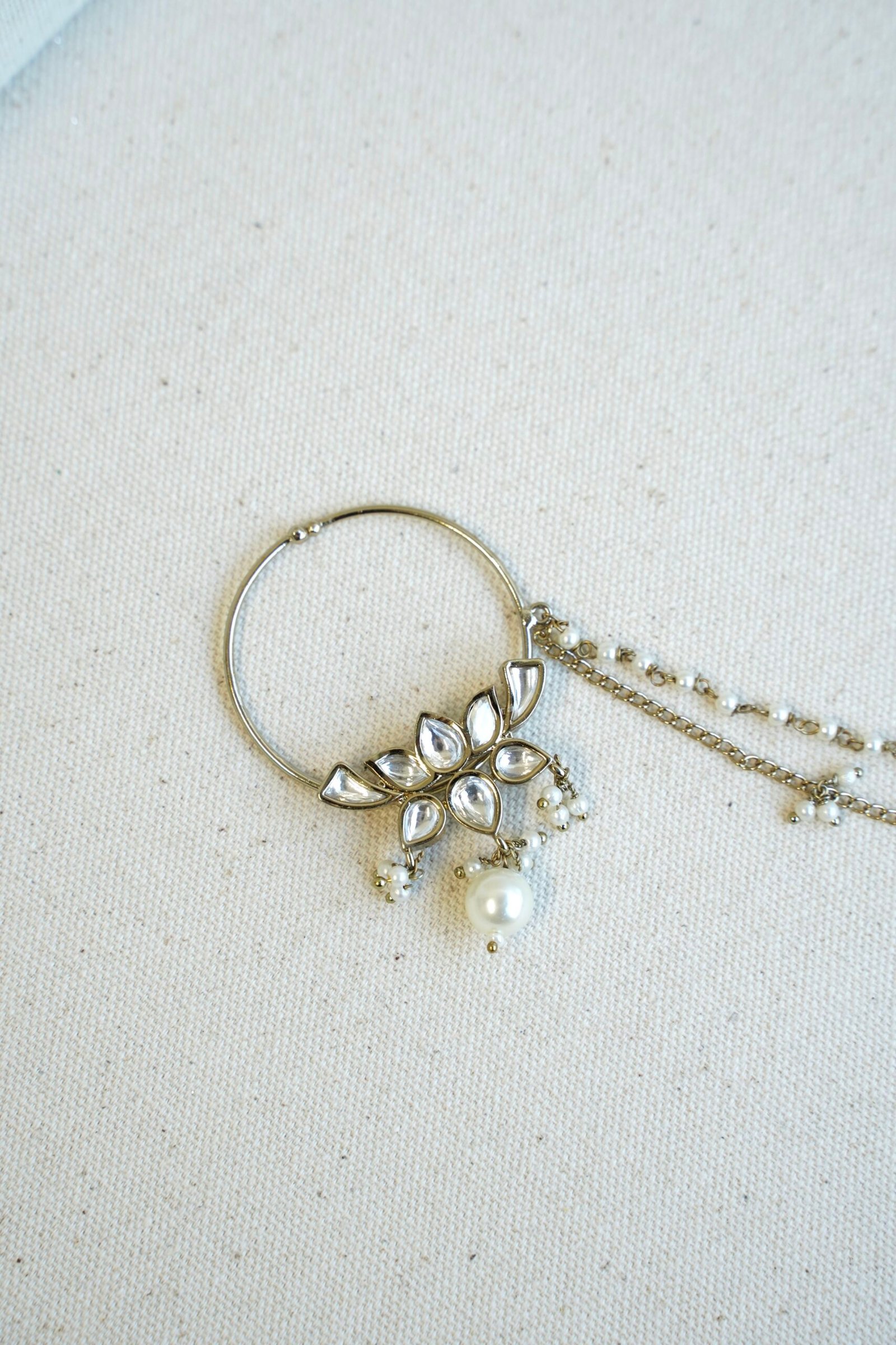 Mehndi polish Kundan nath featuring a lotus design, hanging pearl, and two-layer pearl chain by Seyora Jewels.