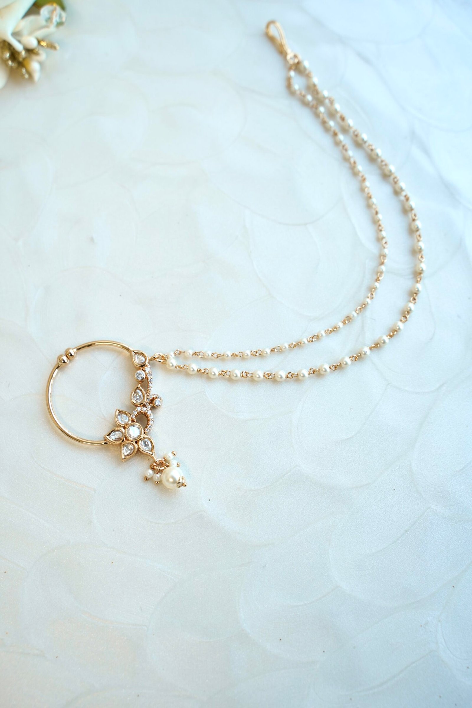 Dainty gold polish Kundan nath featuring a sparkly tiny zircon set, floral details, and a two-layer micro-beaded chain by Seyora Jewels.