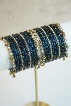 Blue glass bangle stack with delicate ghungroo accent bangles for weddings, mehendi events, and festive wear.