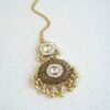 Traditional kundan tikka with elegant golden bead detailing for bridal, wedding, and festive wear.