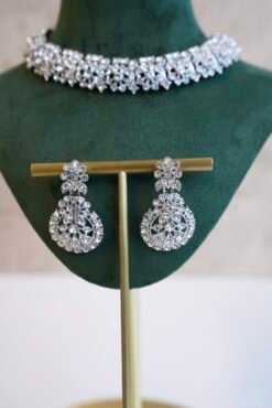 Delicate silver-plated petite stone necklace set with matching sparkly drop earrings and small pendant tikka.