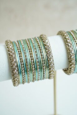 Blue metal bangle stack featuring statement kata bangles on each end, perfect for summer weddings and festive occasions.