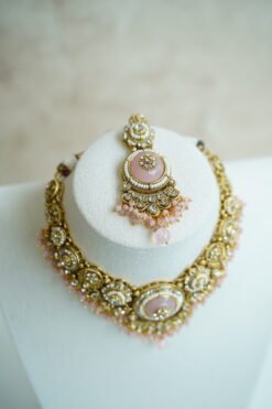 Lightweight pink artificial Kundan necklace set with matching drop earrings and Maang Tikka for South Asian weddings.