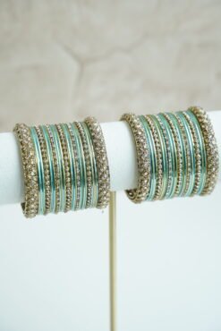 Blue metal bangle stack featuring statement kata bangles on each end, perfect for summer weddings and festive occasions.