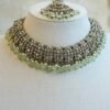 Zoya necklace set in light green with clear stones, hanging light green beads, matching earrings, and tikka