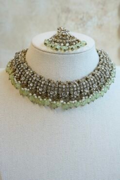 Zoya necklace set in light green with clear stones, hanging light green beads, matching earrings, and tikka