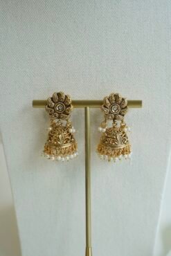 Pair of matching antique matte gold jhumka earrings featuring an intricate floral top design and tiny hanging pearl beads.