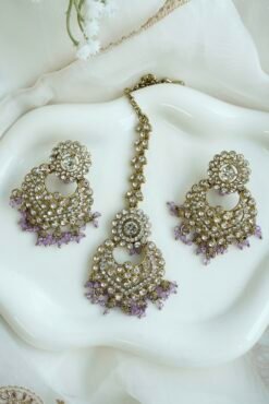 Seyora sparkling festive jewelry set featuring clear stone earrings with hanging crystal beads and a matching maang tikka.