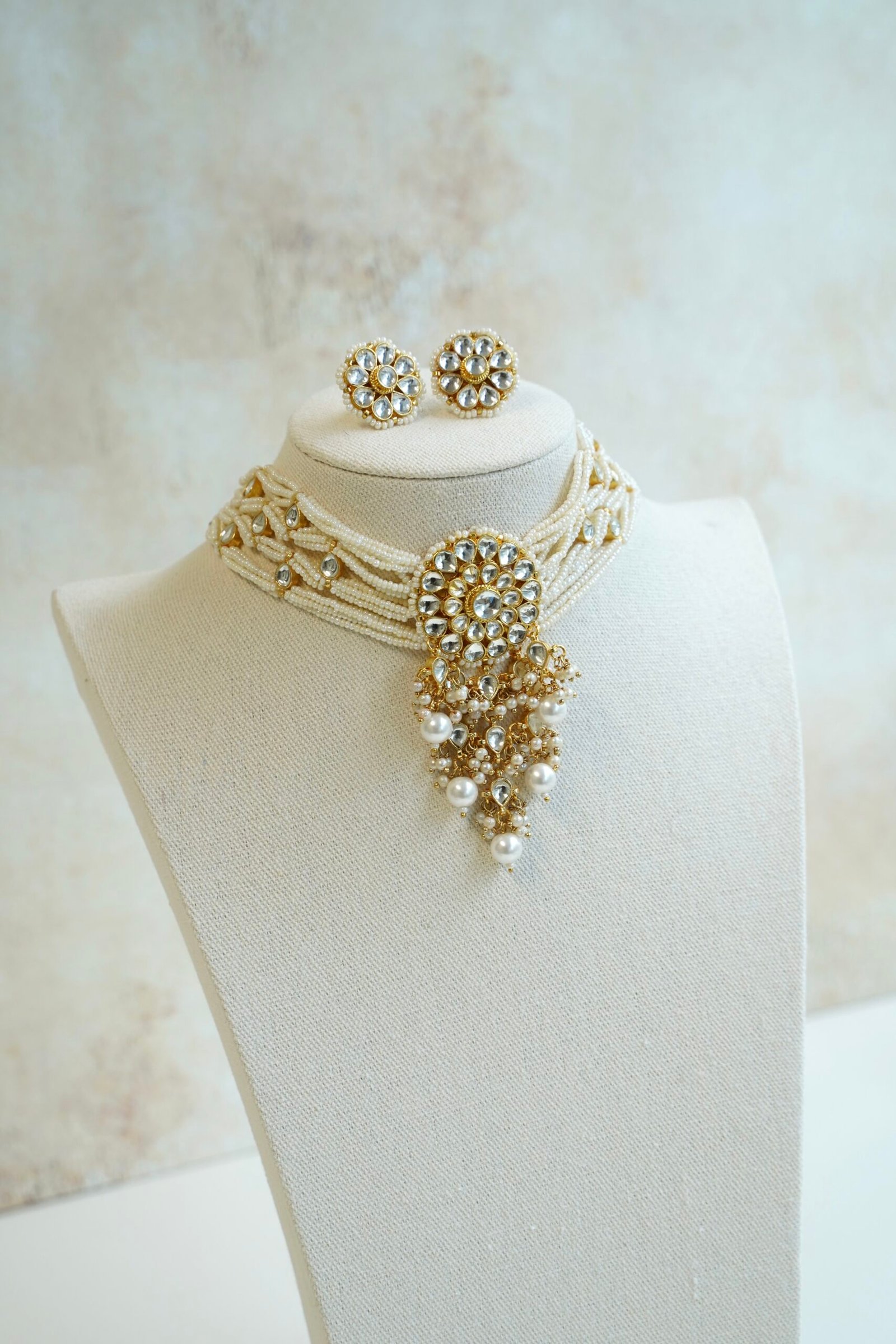 Seyora Jewels modern pachi kundan beaded choker necklace featuring a 3.5-inch floral centerpiece with hanging beads and matching square floral earrings.