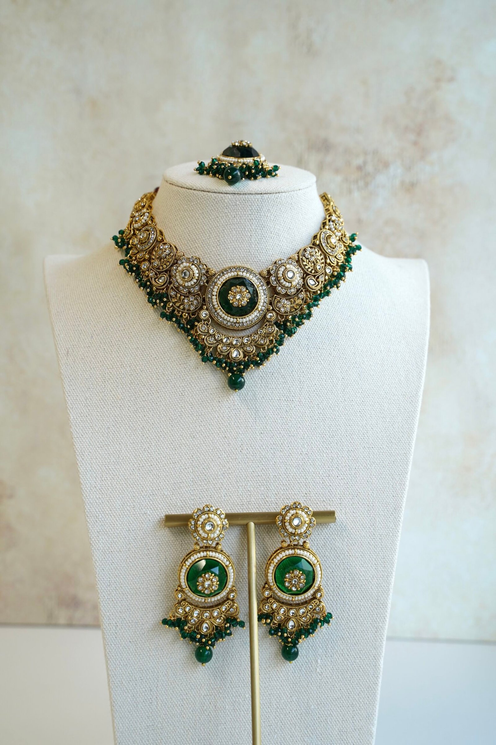 Lightweight green artificial Kundan necklace set with matching drop earrings and Maang Tikka for South Asian weddings.