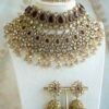 Seyora two-layer South Asian bridal necklace set featuring maroon stone and crystal bead settings with a choker, longer necklace, matching jhumka earrings, and a maang tikka