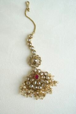 Seyora two-layer South Asian bridal necklace set featuring rani pink stone and pearl settings with a choker, longer necklace, matching jhumka earrings, and a maang tikka.