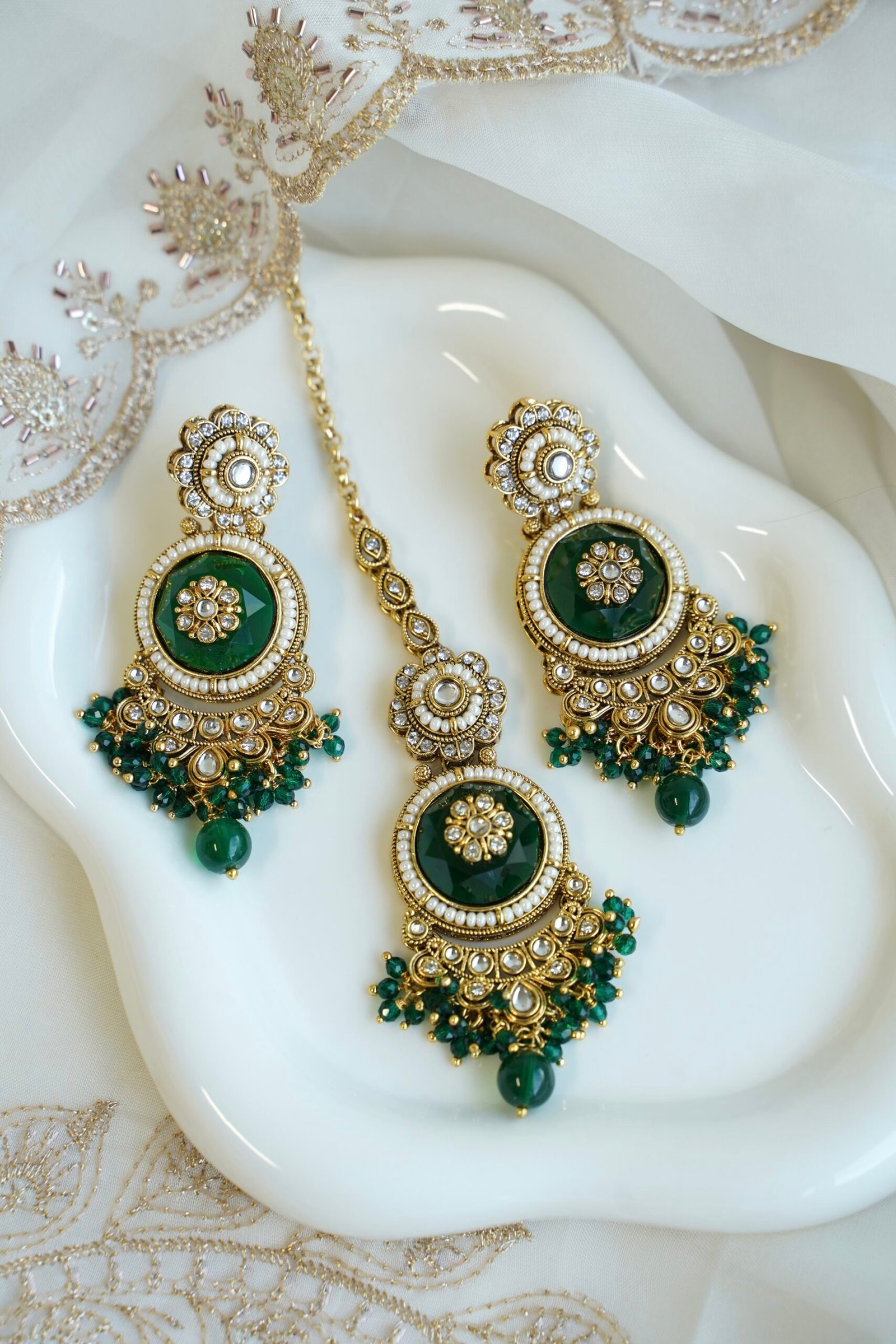 Lightweight green artificial Kundan necklace set with matching drop earrings and Maang Tikka for South Asian weddings.
