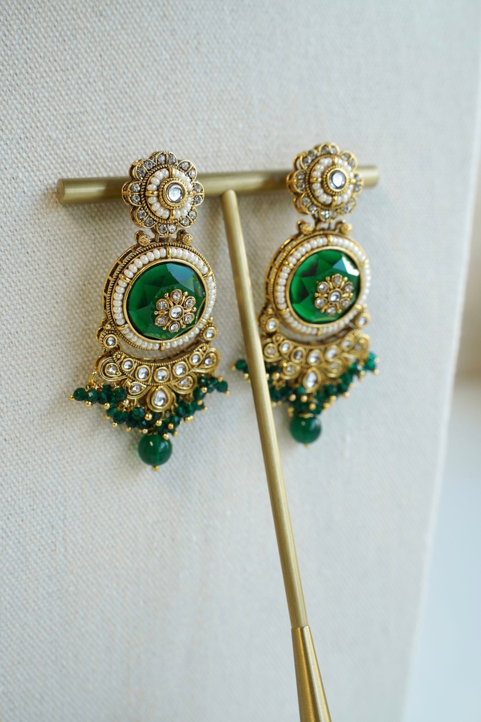 Lightweight green artificial Kundan necklace set with matching drop earrings and Maang Tikka for South Asian weddings.