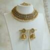 Complete antique matte gold South Asian bridal bridal set including a flexible choker necklace, floral jhumka earrings, and matching maang tikka with pearl drop clusters