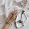 Seyora Jewels Mira heritage hathpan hand chain featuring an adjustable rani pink stone ring and green bead wrist detailing.