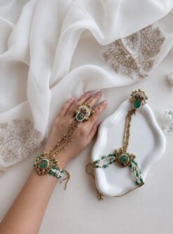 Seyora Jewels Mira heritage hathpan hand chain featuring an adjustable rani pink stone ring and green bead wrist detailing.