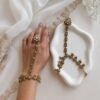 Seyora Jewels Diya floral Kundan hathpan hand chain featuring a kundan-studded flower ring and a detailed connecting chain linked to an adjustable wrist strap.