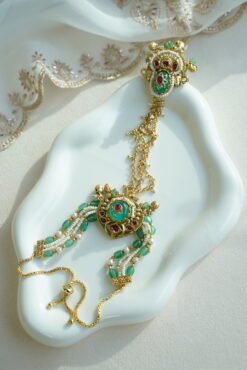 Seyora Jewels Mira heritage hathpan hand chain featuring an adjustable rani pink stone ring and green bead wrist detailing.