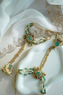 Seyora Jewels Mira heritage hathpan hand chain featuring an adjustable rani pink stone ring and green bead wrist detailing.