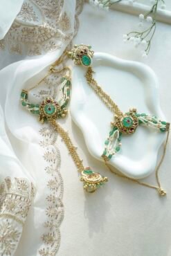 Seyora Jewels Mira heritage hathpan hand chain featuring an adjustable rani pink stone ring and green bead wrist detailing.