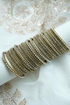 An elegant stack of South Asian bangles featuring a vibrant mix of different stone detailing and crystal embellishments by Seyora Jewels.