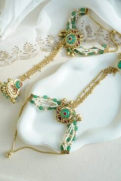 Seyora Jewels Mira heritage hathpan hand chain featuring an adjustable rani pink stone ring and green bead wrist detailing.