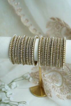 An elegant stack of South Asian bangles featuring a vibrant mix of different stone detailing and crystal embellishments by Seyora Jewels.
