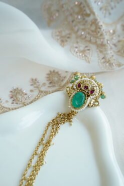 Seyora Jewels Mira heritage hathpan hand chain featuring an adjustable rani pink stone ring and green bead wrist detailing.