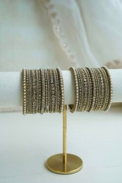 An elegant stack of South Asian bangles featuring a vibrant mix of different stone detailing and crystal embellishments by Seyora Jewels.