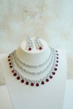 Luxe AD layered necklace set with maroon and clear stone detailing, South Asian bridal jewelry
