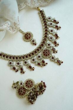 Samaira waterfall necklace set with maroon stones, matching jhumka earrings and tikka, South Asian festive jewelry