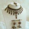 Samaira waterfall necklace set with maroon stones, matching jhumka earrings and tikka, South Asian festive jewelry