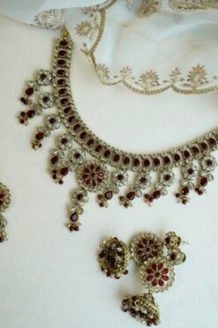 Samaira waterfall necklace set with maroon stones, matching jhumka earrings and tikka, South Asian festive jewelry